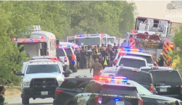 The tractor-trailer  with 46 dead migrants, first right and security officials in San Antonio