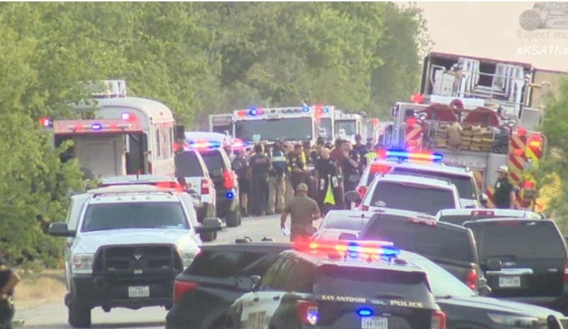 The tractor-trailer with 46 dead migrants, first right and security officials in San Antonio