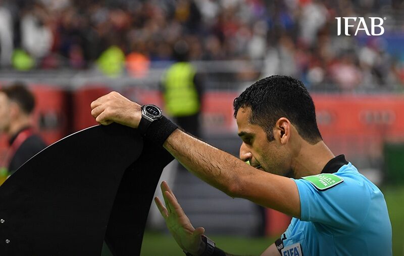 a referee consults VAR