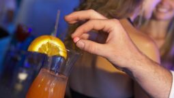Man Drugging Woman’s Drink In Bar