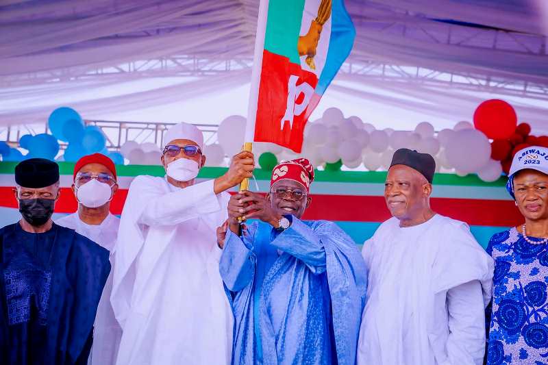 Tinubu with APC flag, with Buhari and others