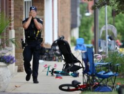 A police officer walks through things abandoned by July 4 revellers in Highland Park Illinois