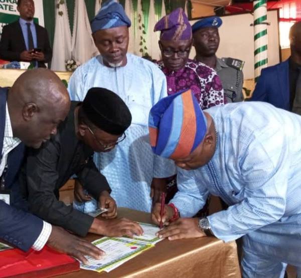 The Osun governor-elect signing to receive his certificate of return
