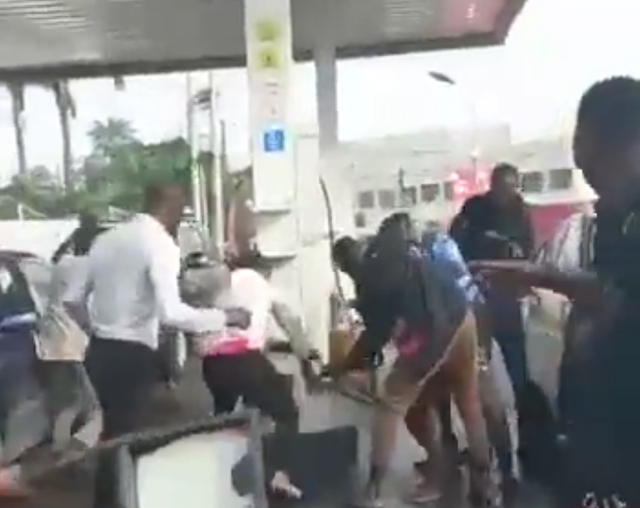 Bystanders seize a woman wetting Lagos Petrol station with petrol
