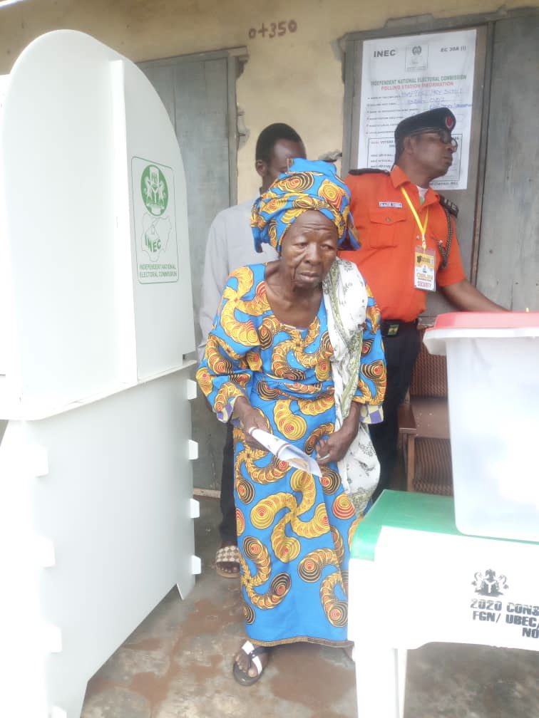The woman going to drop her ballot paper inside the box