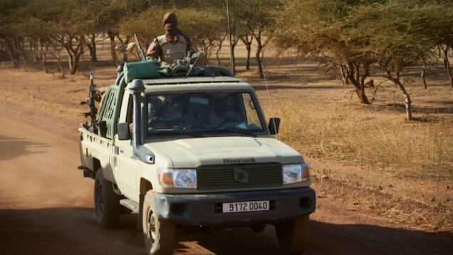 a military vehicle patrols rural Burkina Faso