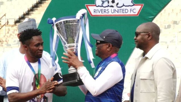 Rivers State governor, Nyesom Ezenwo Wike (middle); Minister of Youths and  Sports, Sunday Dare (right) and the Captain Rivers United, Festus Austin receiving  the 2021/2022 Nigeria Professional Football League trophy from Governor Wike at the Adokiye Amiesimaka Stadium, Port Harcourt on Sunday.