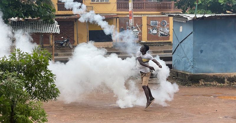 A protester in Freetown braves teargas
