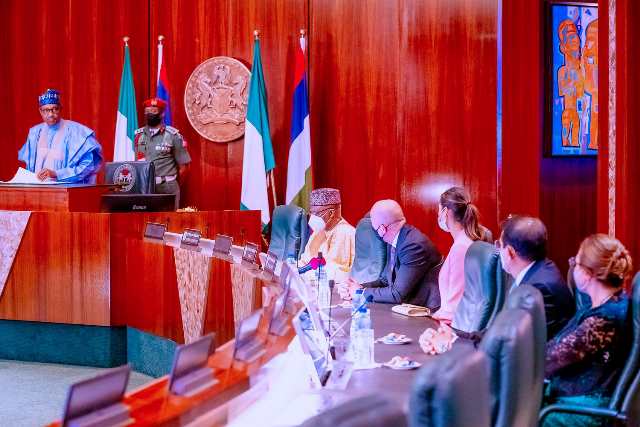 The president with the foreign envoy