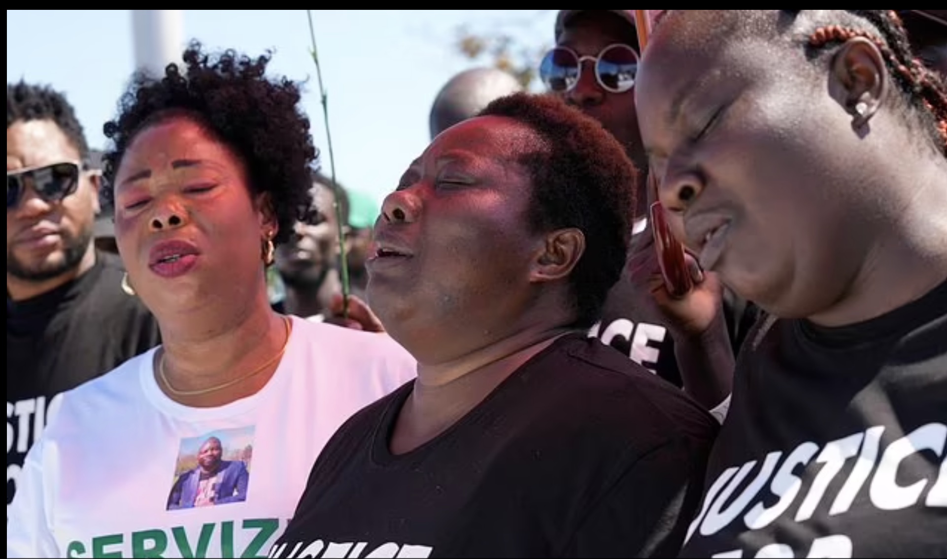Charity Oriakhi, middle, leads the march for Alika Ogorchukwu