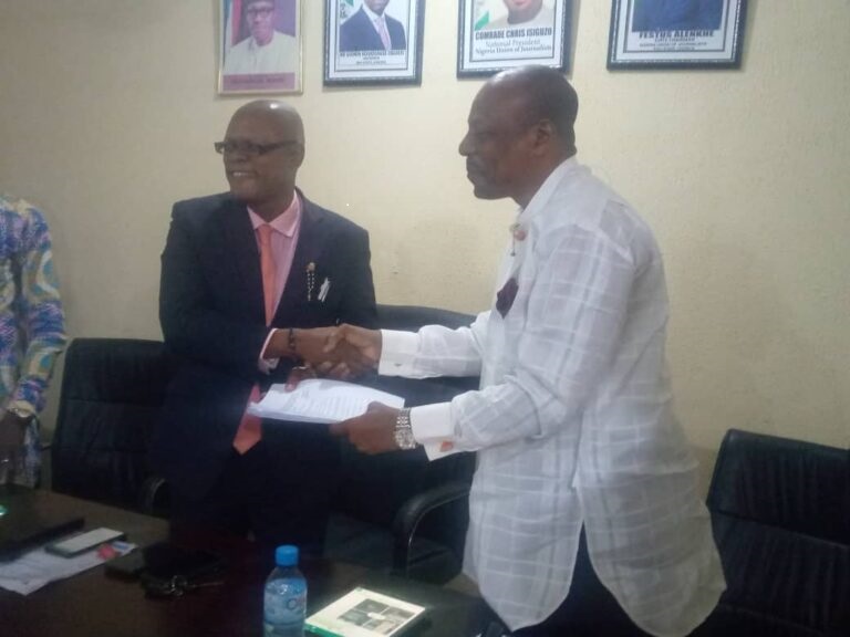 Dotimi Tawari presenting a copy of the draft Bill to Edo NUJ Chairman, Festus Alenkhe