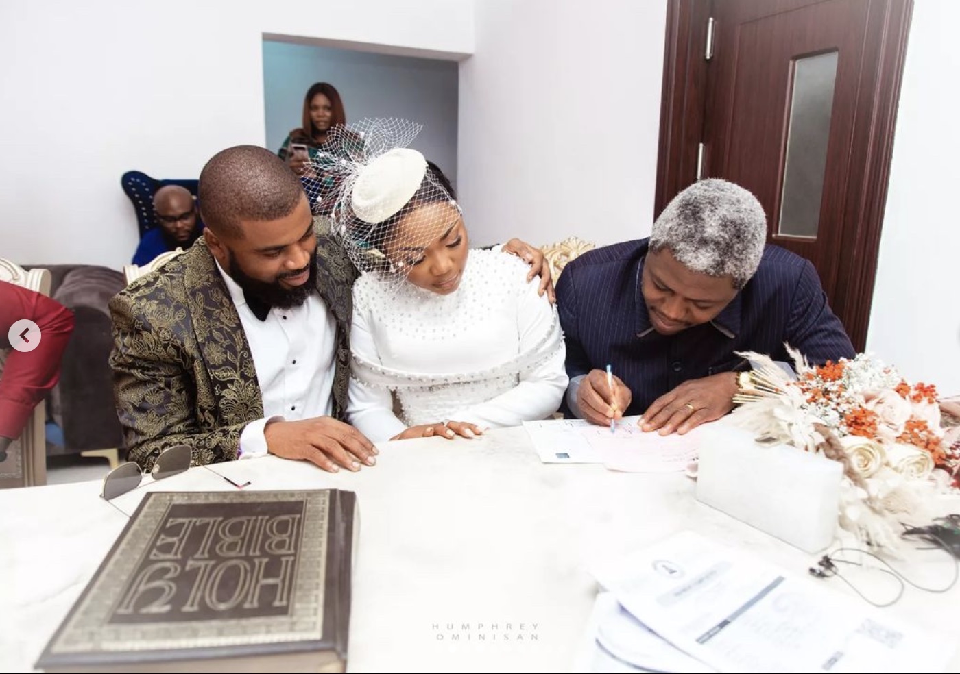Witness signs the register at the wedding of Mercy Chinwo and Pastor Blessed