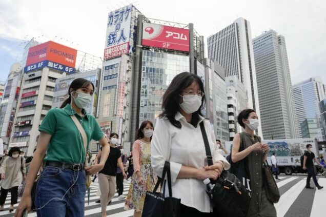 people wear masks in Tokyo Japan as COVID-19 cases surge