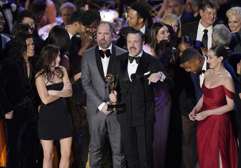 Jason Sudeikis, center, and the cast of "Ted Lasso" accept the Emmy for outstanding comedy