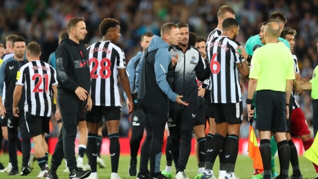 Newcastle United’s players confront the officials after their loss to Liverpool