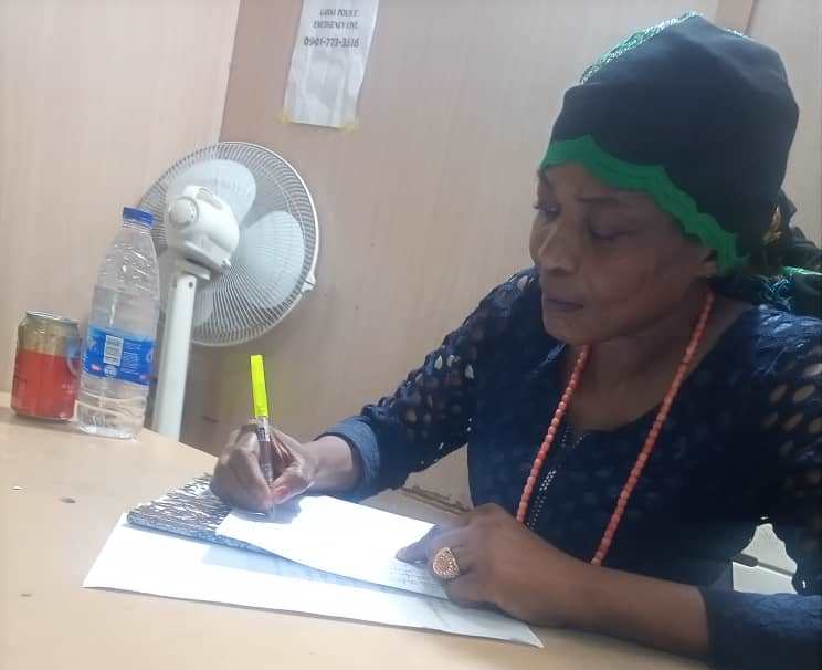 Prof. Duke-Abiola writing statement at police station.