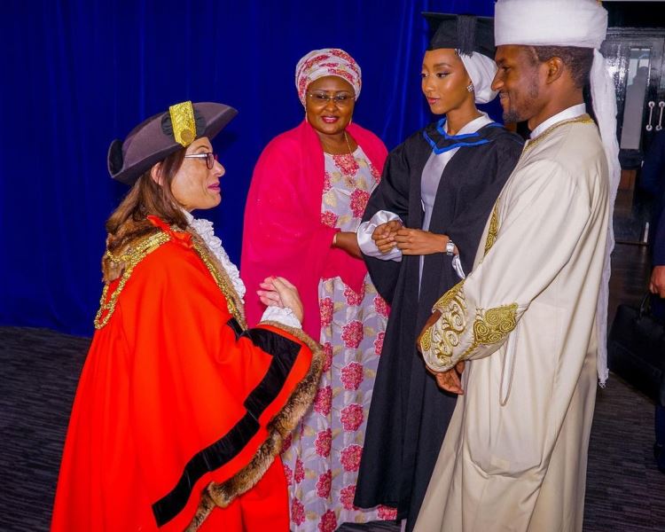 Aisha and her children with a representative of the school