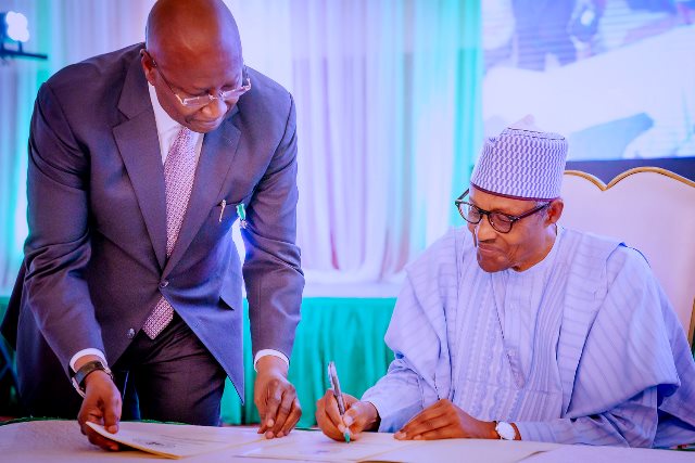 Buhari signing of Executive Order 012