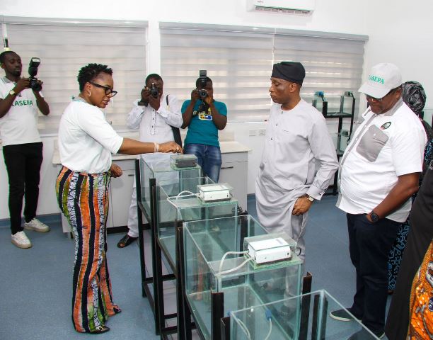 The General Manager, LASEPA, Dr. Dolapo Fasawe, explaining a point to the HC (MOE & WR), Mr. Tunji Bello during the tour of the laboratories