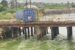 A fully loaded container knocks two vehicles into the Aleto River in Eleme LGA of Rivers State, before falling on top of the bridge.