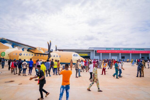 Excited citizens taking selfies with the first aircraft to land at Ekiti Airport
