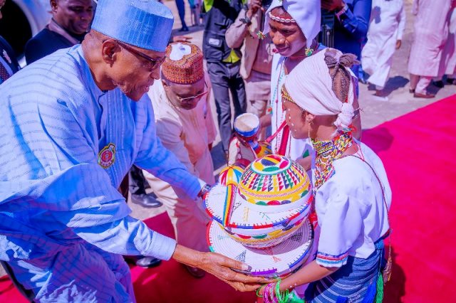 Buhari presented with local Fulani product by a girl