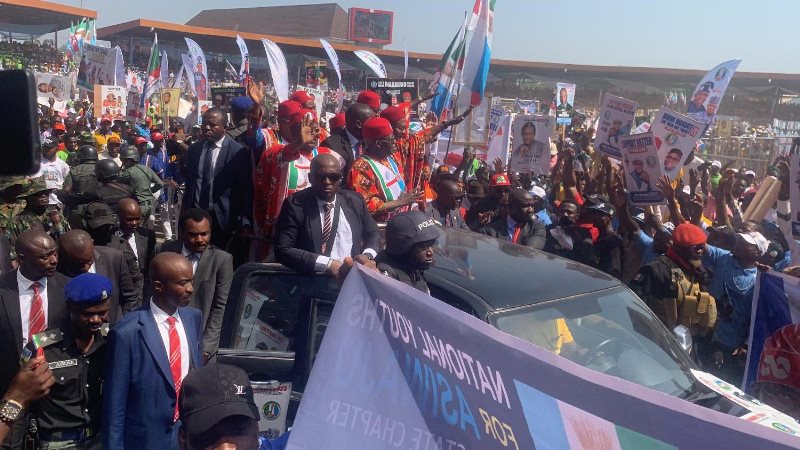 Tinubu and Governor David Umahi waving the huge crowd at the rally