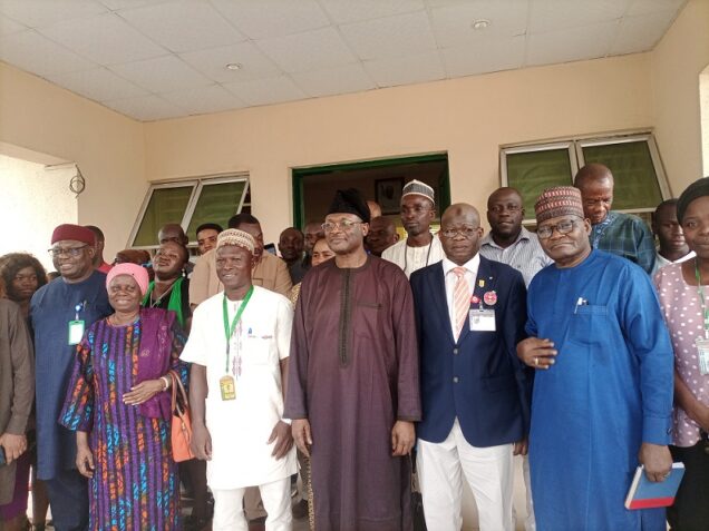 INEC Chairman Prof Mahmood Yakubu in group photograph with the commission staff in Abeokuta, Ogun State