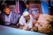 Tinubu and Shettima with the man given alms to