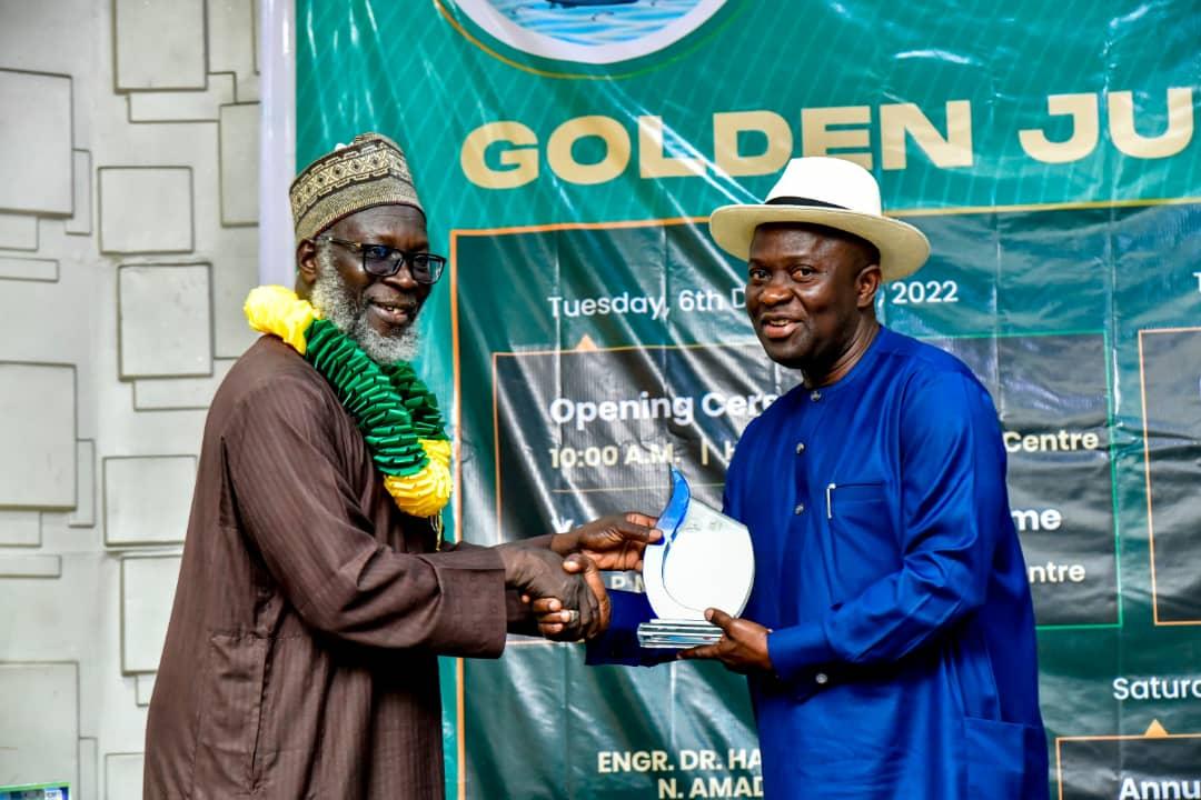 Chief of Staff to Rivers State governor, Engineer Emeka Woke (right) receiving 'Distinguish award of Excellence ' in infrastructural development in Rivers State on behalf of Governor Nyesom Ezenwo Wike from the President, Nigeria Society of Engineers (NSE), Tasiu Sa’ad Gidari-Wudil (left) at the 50th anniversary of NSE Port Harcourt branch in Port Harcourt on Saturday.