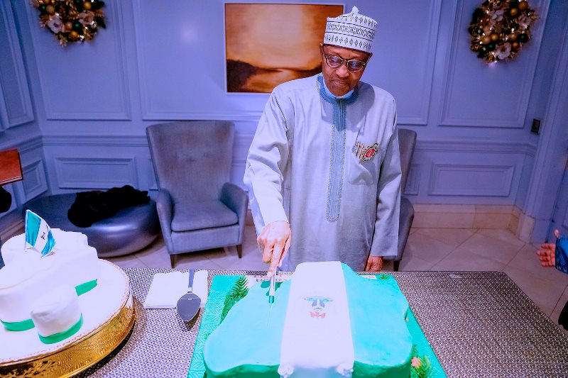 Buhari cutting his 80th birthday cake