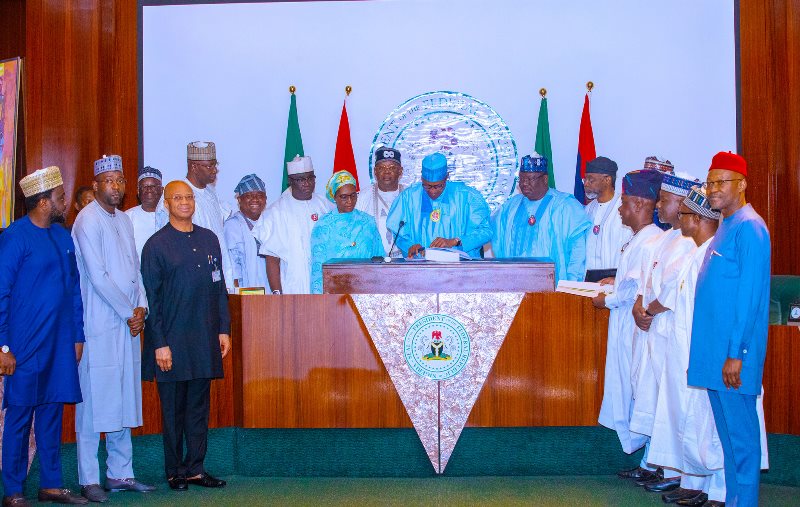 Buhari signing the 2023 budget into law on Tuesday