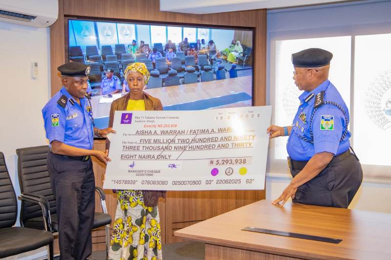 IGP presents cheque to one of the beneficiaries