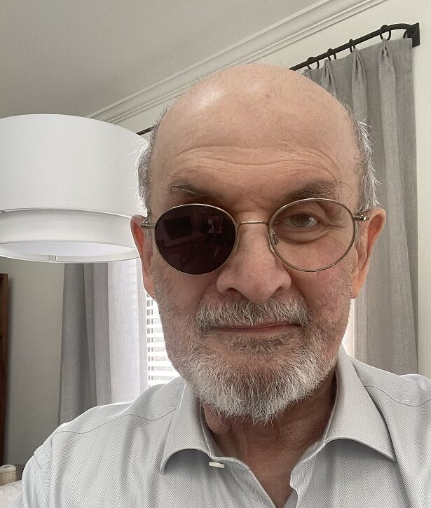 Six months after he was attacked in New York, Salman Rushdie shares photo showing scars to his face and a darkened lens in his glasses