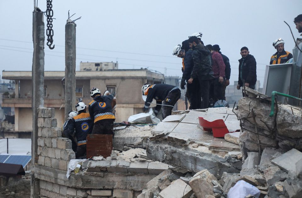 Rescuers search for survivors under the rubble of a damaged building, following an earthquake, in rebel-held Azaz, Syria February 6, 2023. REUTERS/Mahmoud Hassano
