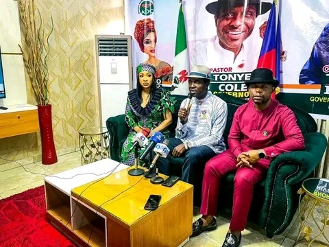 Tonto Dike,(left) of the African Democratic Congress,ADC, Deputy Governorship candidate raising hand of Tonye Cole and Tonte Ibraye wearing red colour 'Senator