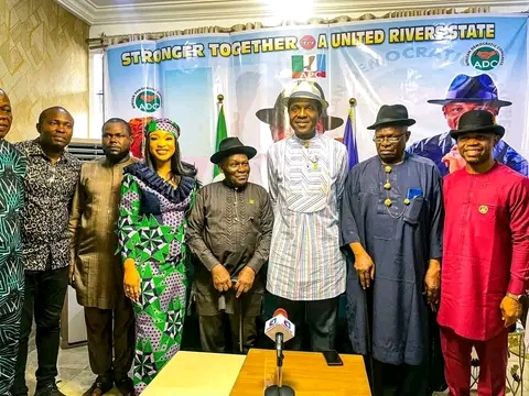 Tonto Dike,(left) of the African Democratic Congress,ADC, Deputy Governorship candidate raising hand of Tonye Cole and Tonte Ibraye wearing red colour 'Senator