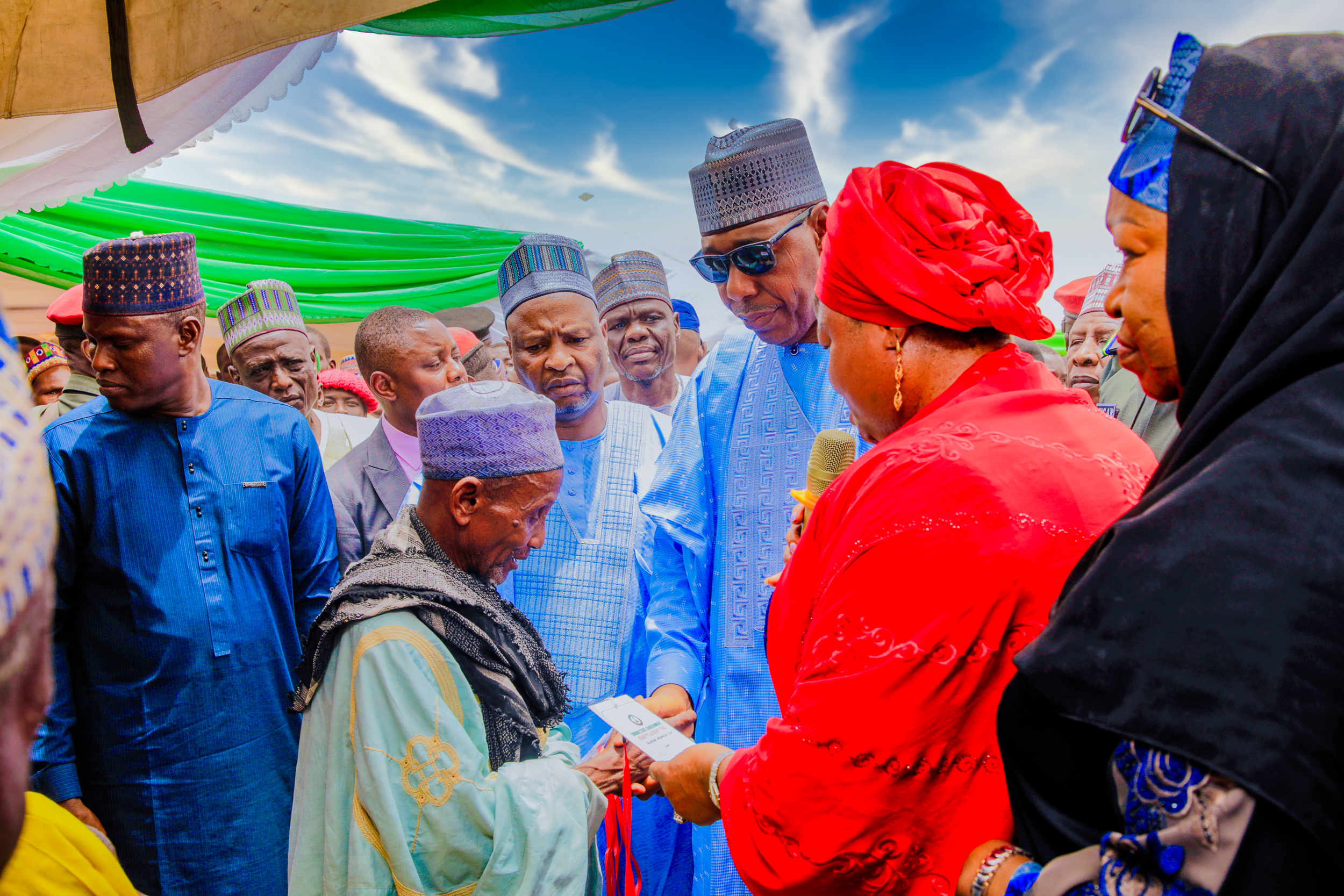 Governor of Borno State, Babagana Umara Zulum and the SSA to the President on SDGs, Princess Adejoke Orelope-Adefulire with one of the beneficiaries of the the 200 units of 2 bedroom houses in IDP Camp in Nganzai, Borno State
