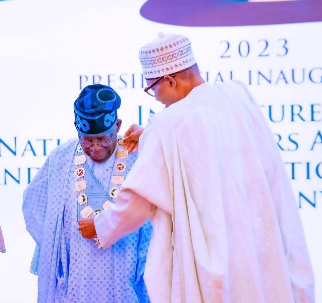 Buhari decorating Tinubu with the highest award.