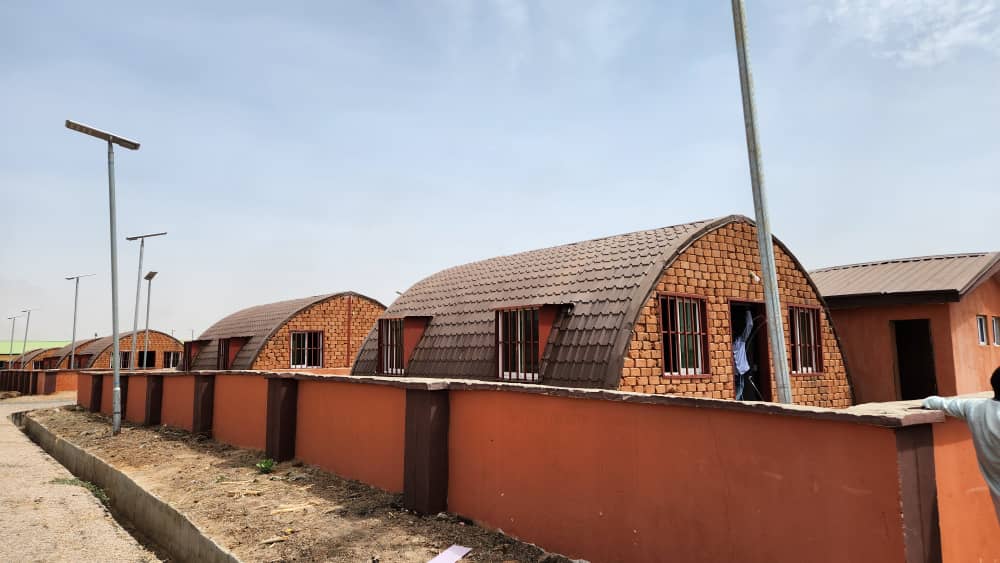 The 200 housing units delivered by OSSAP-SDGs at Nganzai LG. (Insert) Governor of Borno State, Babagana Umara Zulum and the SSA to the President on SDGs, Princess Adejoke Orelope-Adefulire at the commissioning of 200 units of 2 bedroom houses in IDP Camp in Nganzai, Borno State