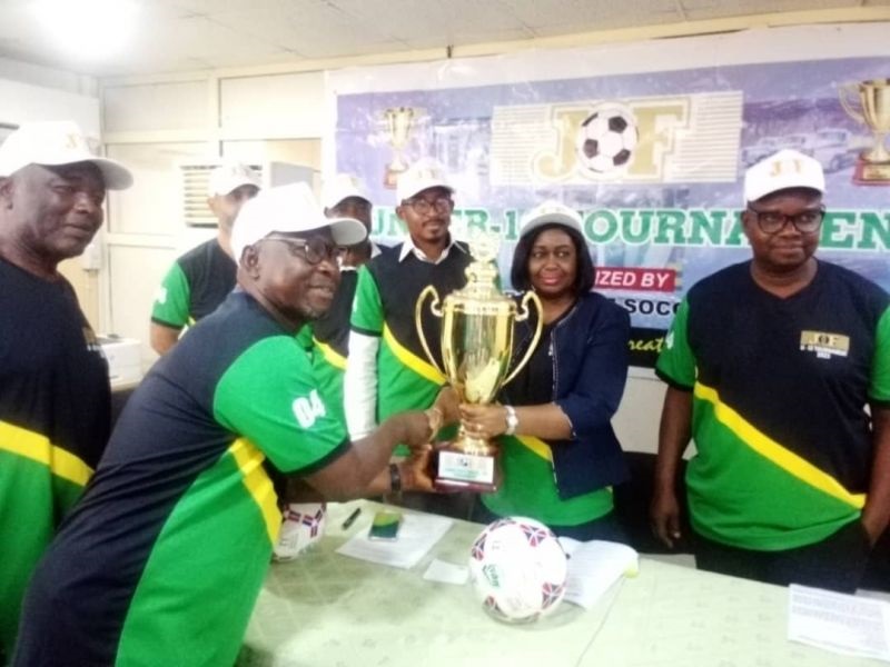 Picture above shows Finance Director of JOF Nigeria Limited, Mrs. Adline Ogunfidodo Presenting the championship trophy to a representative of Lagos State Grassroots Soccer Association