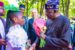 Tinubu handed flower by a Nigerian girl in Paris