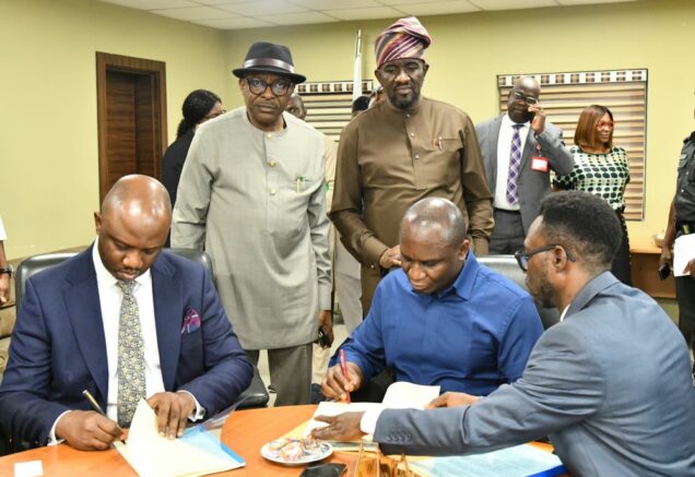 Dr Samuel Ogbuku, Managing Director of Nigeria Delta Development Commission, NDDC, signs partnership agreement on behalf of the Agency and Tolu Odukale,Lead Partner and Head Governance Process, KPMG,signs for his company at NDDC Corporate headquarters,Port Harcourt