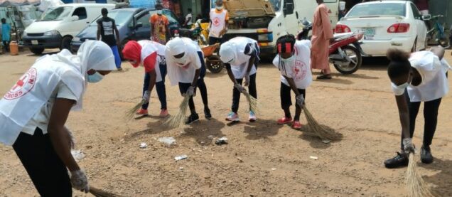 Volunteers of Nigerian Red Cross sweep the Neighborhood Market, Lafia, the capital of Nasarawa State