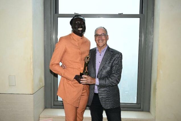 Nhial Deng, left receives his prize in New York