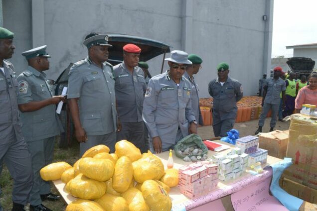 Customs Comptroller Dera Nnadi displaying the seized items at Seme on Friday