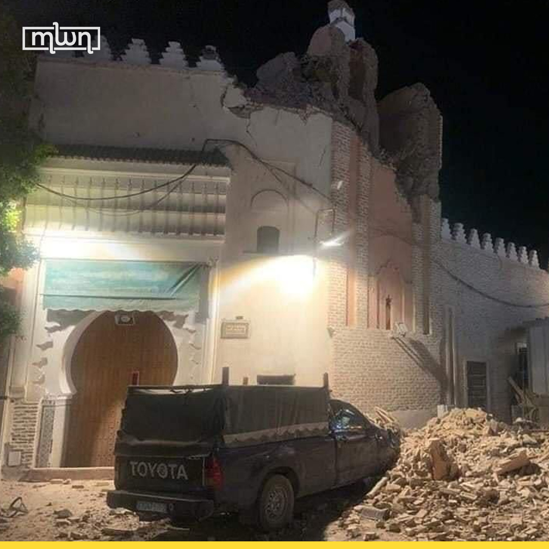 part of a building collapses on a vehicle