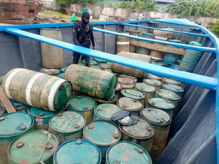 The seized boat with drums of stolen petrol