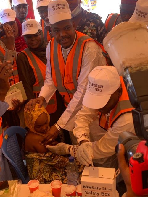 Dr. Labaran Yusuf helps in vaccinating a girl against HPV during the flag-off in Kano on Saturday