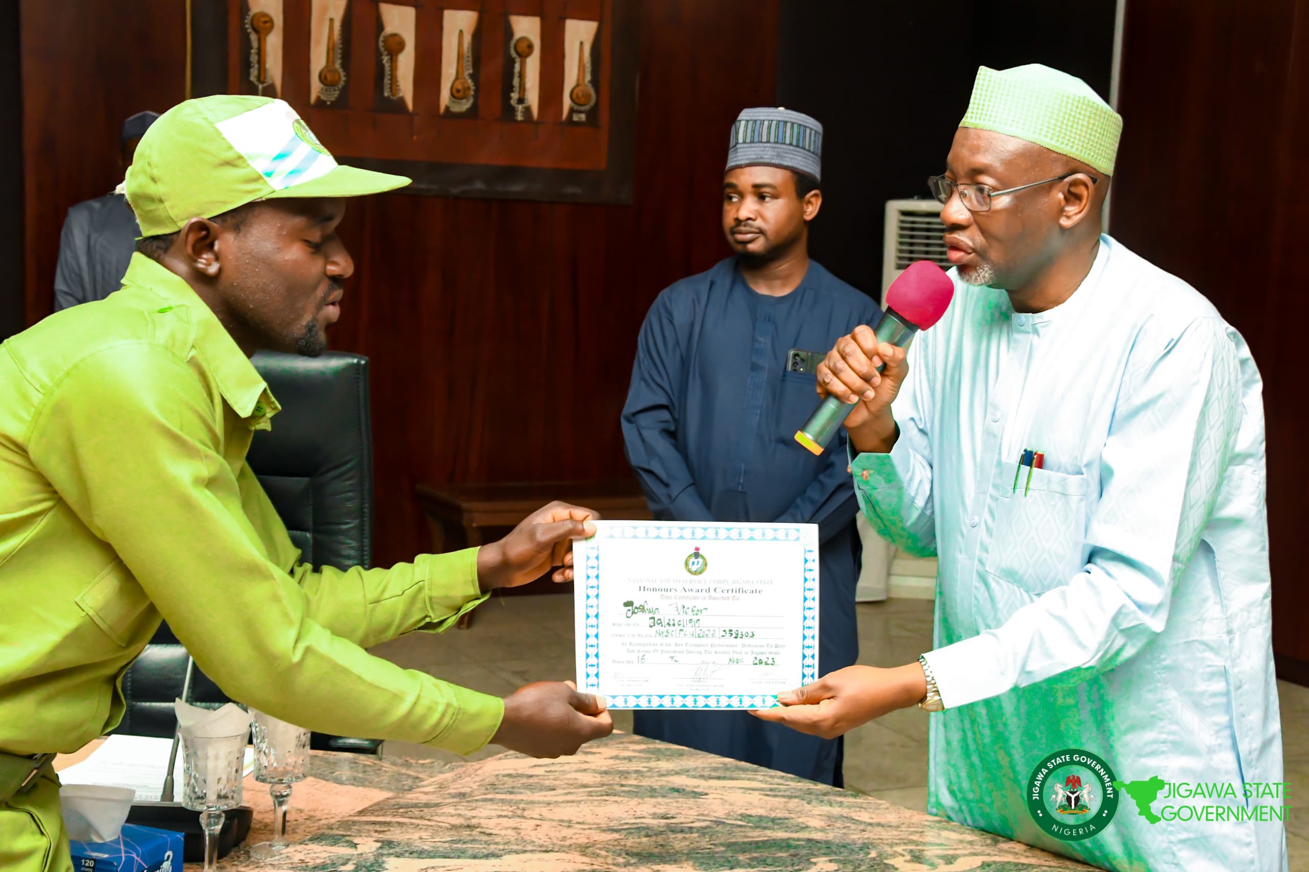 One of the Corps members receiving his certificate from Governor Namadi
